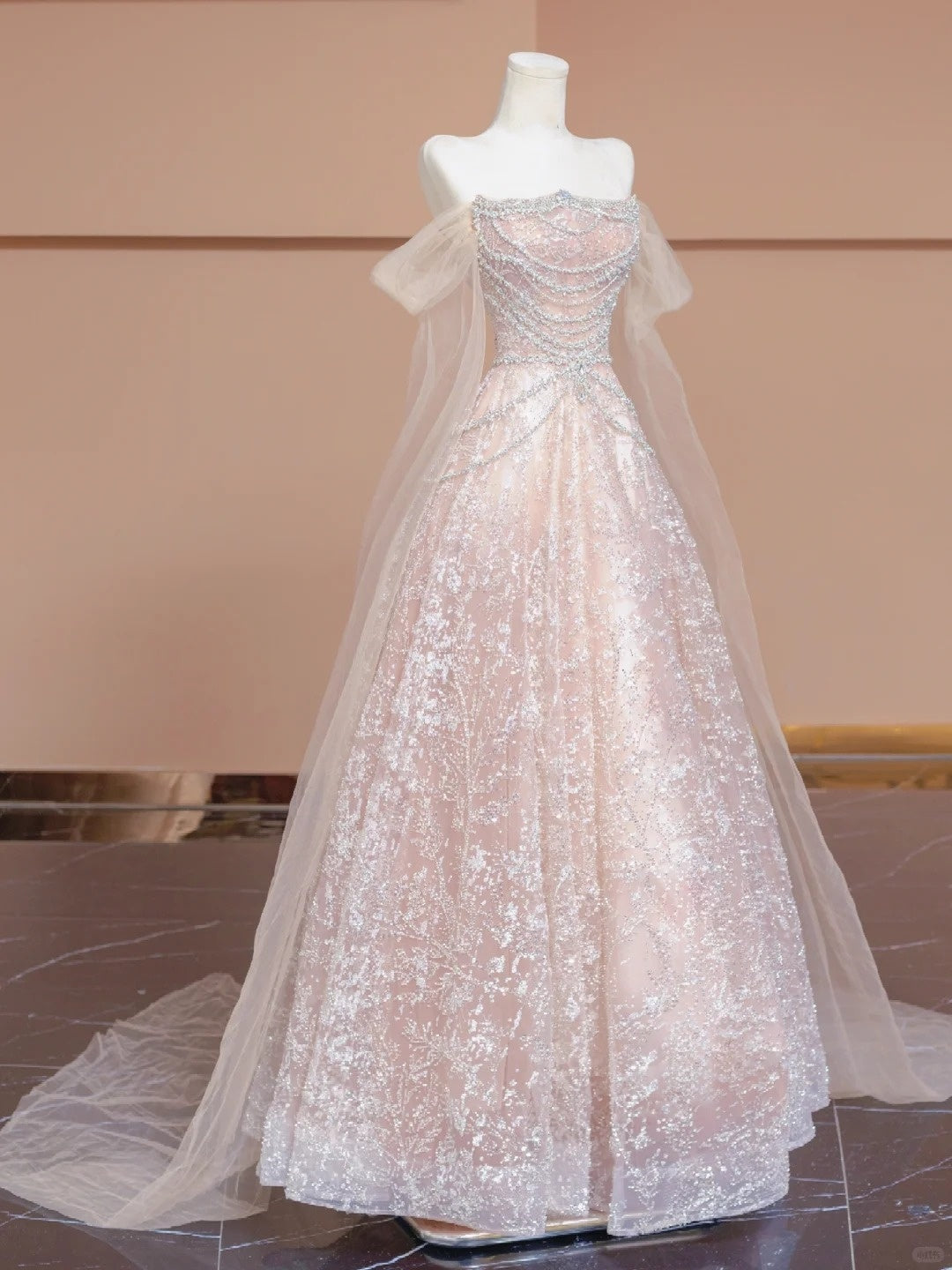 A luxurious, sweet, fairy-like, long, tulle, beaded ball gown in cherry blossom pink. nv5075