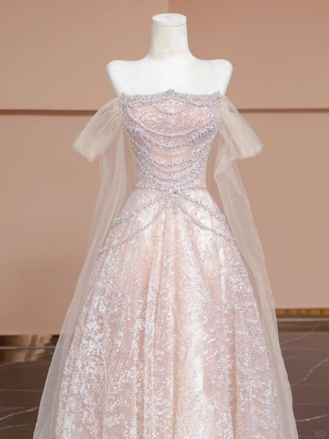 A luxurious, sweet, fairy-like, long, tulle, beaded ball gown in cherry blossom pink. nv5075