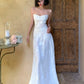 Robe de soirée blanche ornée de broderies raffinées : dos nu à fines bretelles, mousseline fluide, modèle NV6405